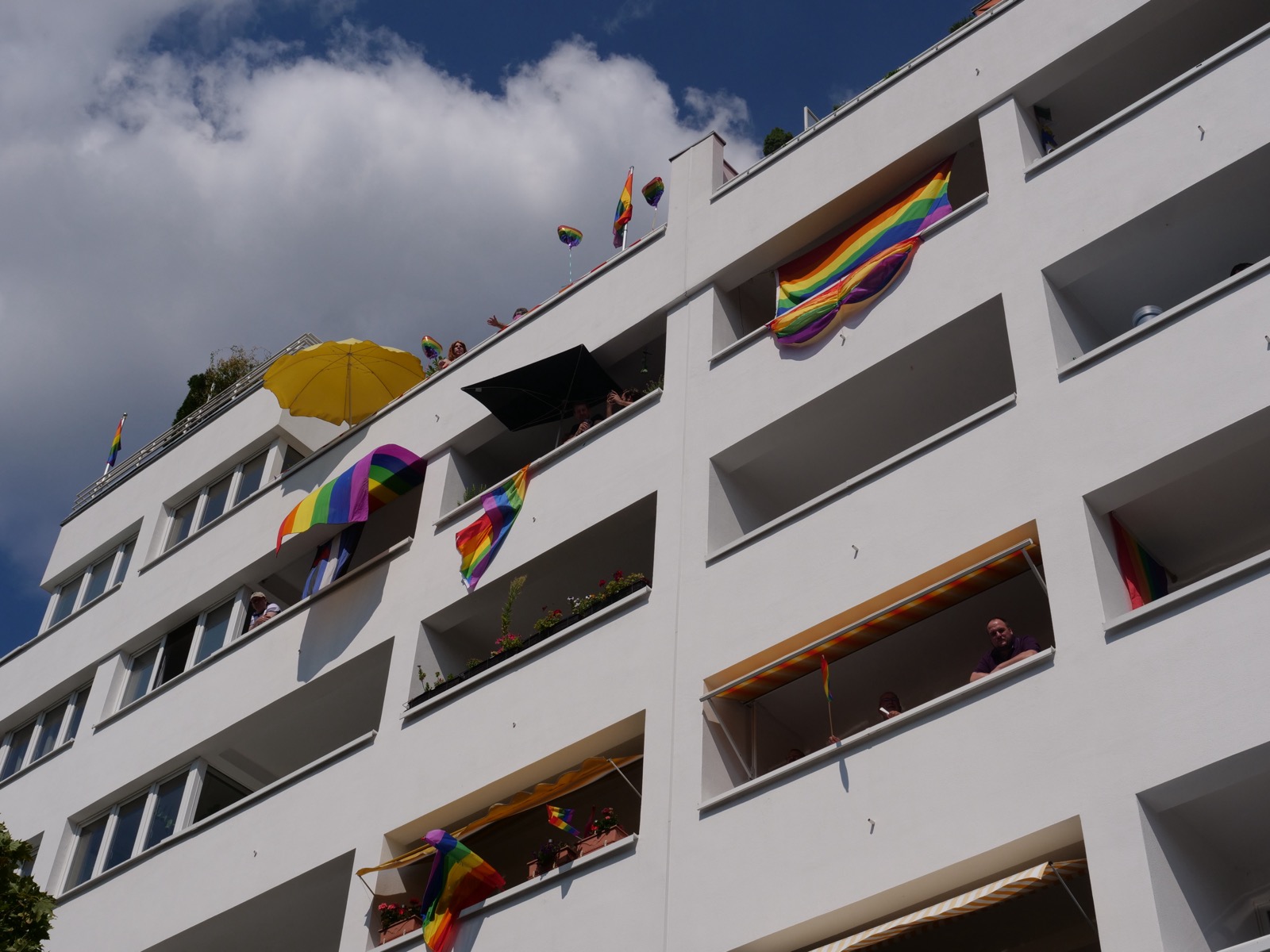Menschen mit Regenbogenfahnen beim Christopher Street Day in Berlin